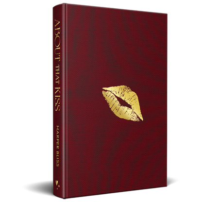 Mockup of the “About That Kiss” special edition hardcover in deep red cloth with gold foil lips on the front and the title on the spine.